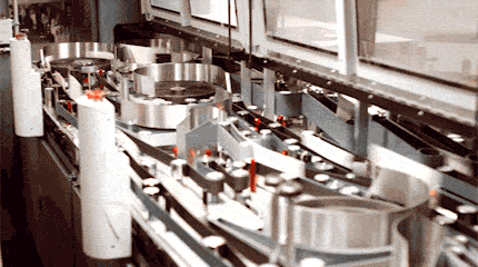 Animated image of mail moving at high speed on belts and around drums in an automated sorting machine.